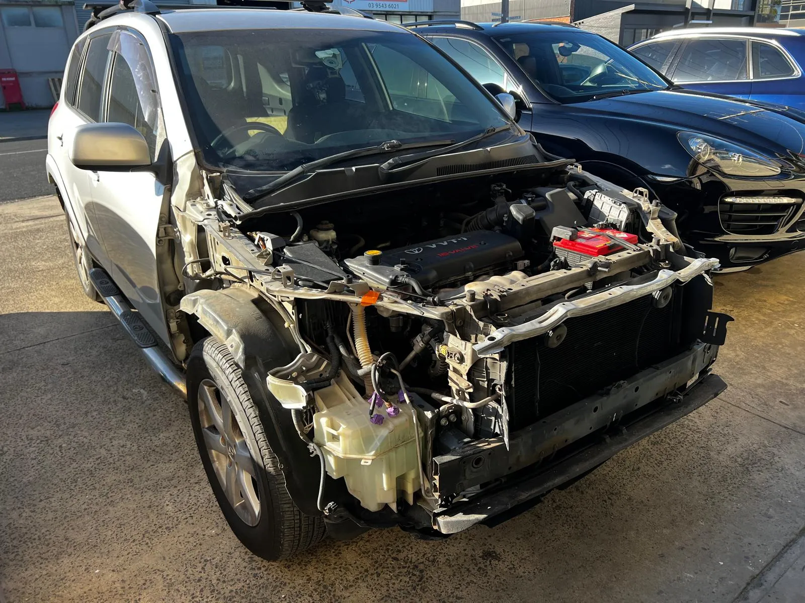 SUV with front-end accident damage, bumper and headlights removed