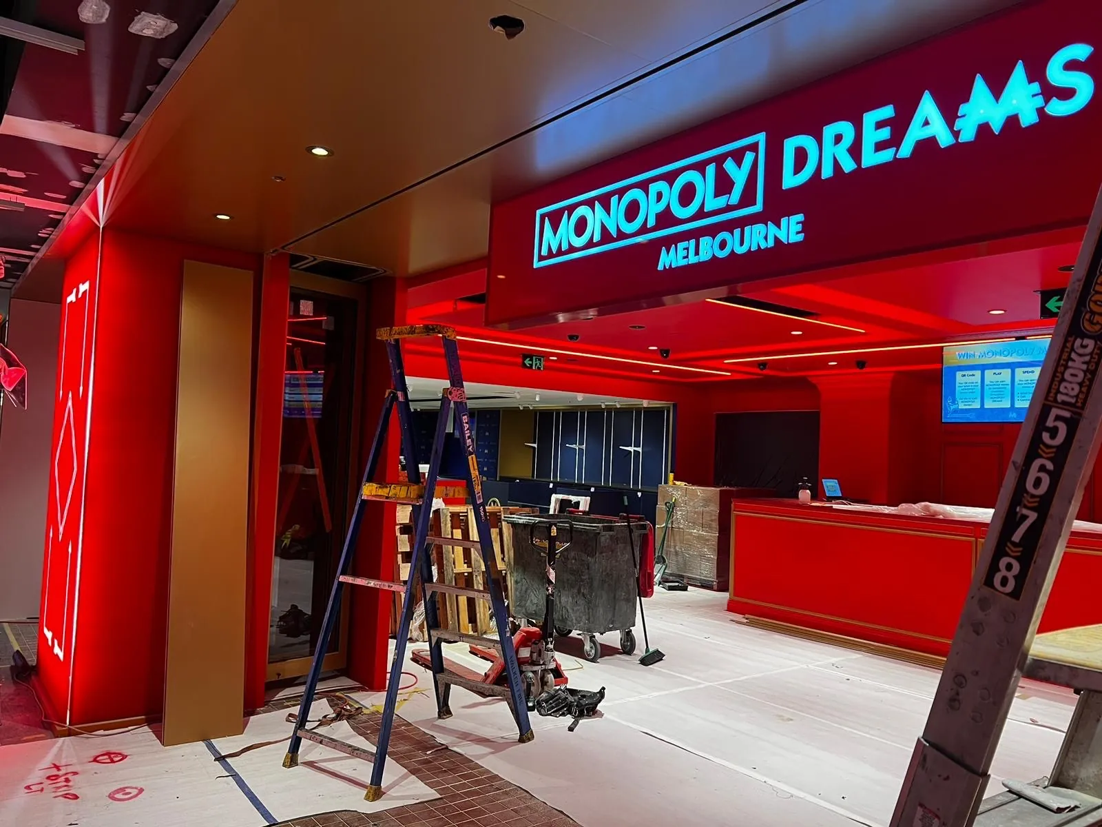 Red-painted entrance, columns and counter during the Monopoly Dreams Melbourne fit-out