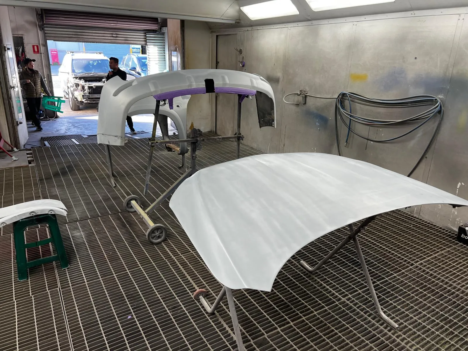Primed panels on stands inside the Lee Murdock Panels spray booth